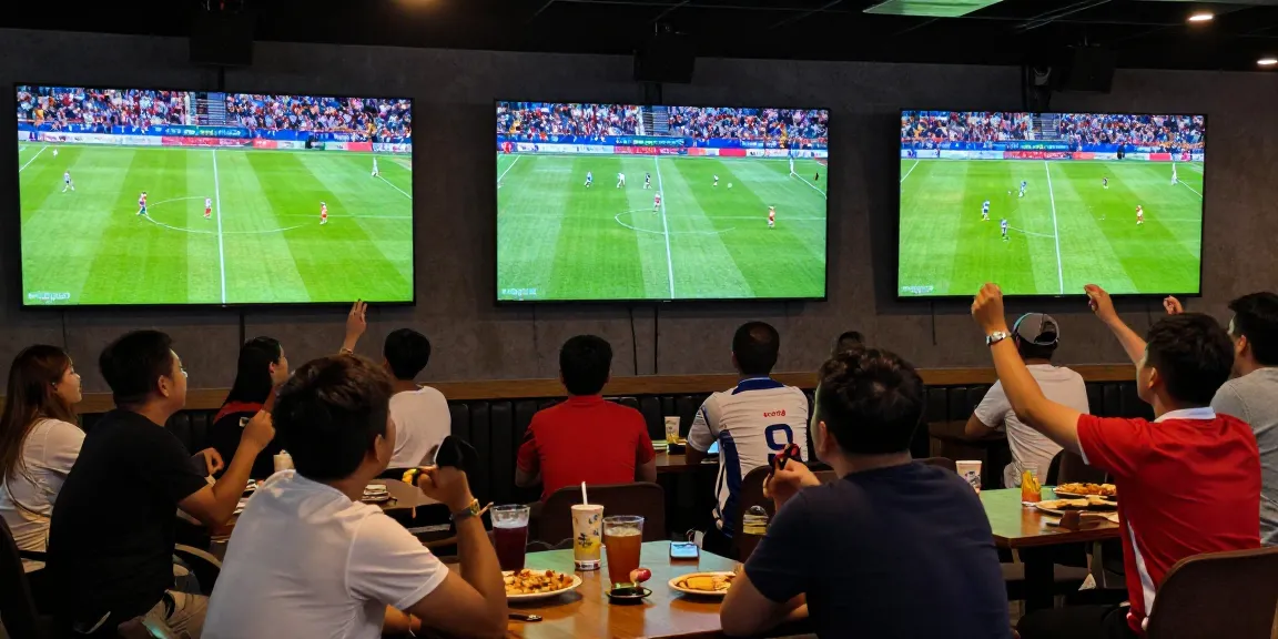 Fans engaging with live soccer matches on Xoilactv in a lively sports bar atmosphere.